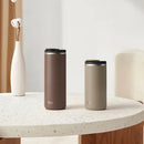 Two insulated tumblers on a marble table with a minimalistic background featuring the TYESO brand.
