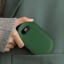 Green portable heating pad being placed into a pocket 